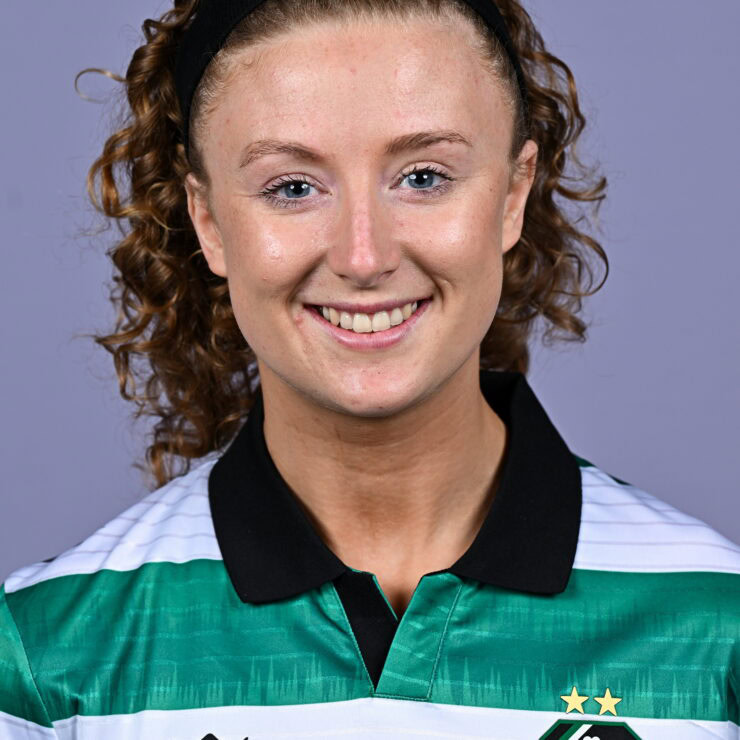 Shamrock Rovers female footballer smiling in team jersey.