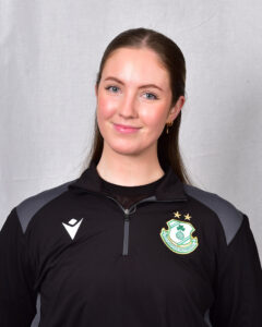 Female football player in Shamrock Rovers kit smiling at camera.