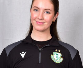 Female football player in Shamrock Rovers kit smiling at camera.