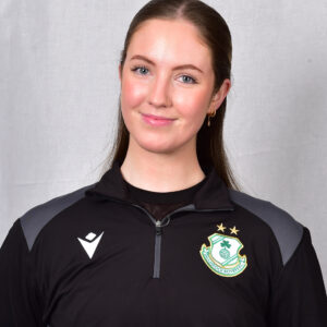 Female football player in Shamrock Rovers kit smiling at camera.