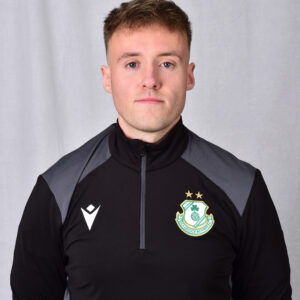 Shamrock Rovers player in team kit with club crest, facing camera.