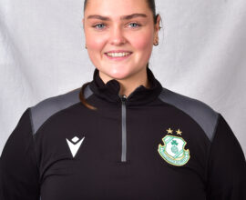 Female Shamrock Rovers player smiling in team kit.