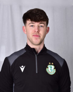 Young Shamrock Rovers football player in team kit with club crest.