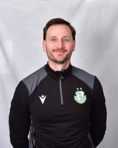 Portrait of Shamrock Rovers coach in team training gear.