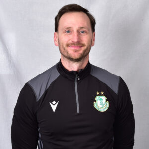 Portrait of Shamrock Rovers coach in team training gear.
