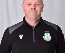 Shamrock Rovers coach in team jacket, smiling, standing against a plain background.