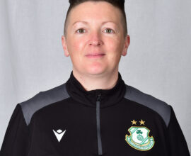 Female Shamrock Rovers player in team kit, smiling, facing camera.