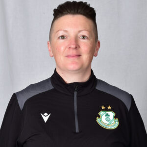 Female Shamrock Rovers player in team kit, smiling, facing camera.