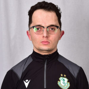 Shamrock Rovers player in team kit with club crest, facing forward.