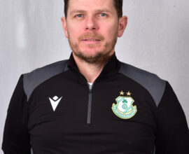 Portrait of Shamrock Rovers coach in team gear, facing camera.