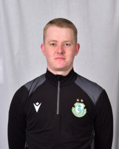 Young Shamrock Rovers player in team training jacket, facing forward.