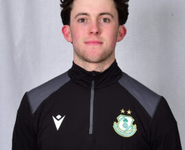 Young Shamrock Rovers football player in team kit, facing camera.