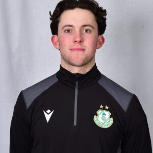 Young Shamrock Rovers football player in team kit, facing camera.