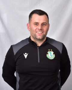 Portrait of Shamrock Rovers coach in team training gear.