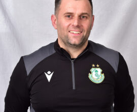 Portrait of Shamrock Rovers coach in team training gear.