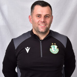 Portrait of Shamrock Rovers coach in team training gear.