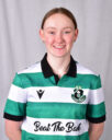Female football player in Shamrock Rovers kit smiling.