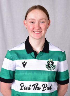 Female football player in Shamrock Rovers kit smiling.