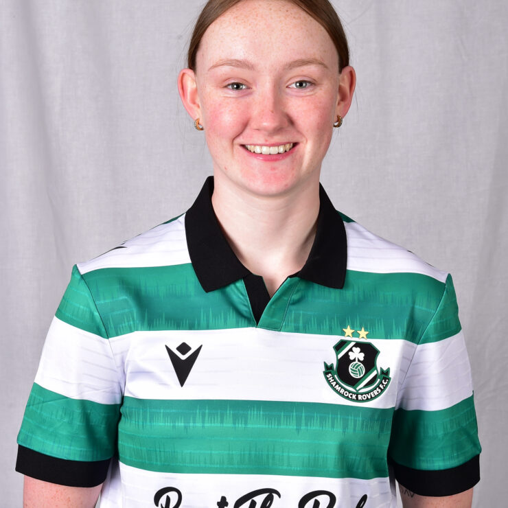Female football player in Shamrock Rovers kit smiling.