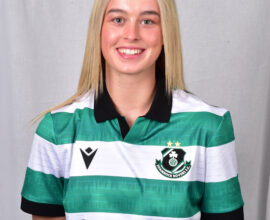 Female Shamrock Rovers player in green and white jersey smiling.