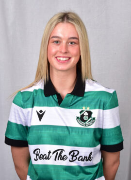 Female Shamrock Rovers player in green and white jersey smiling.