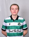 Female Shamrock Rovers player in green and white jersey, standing confidently.