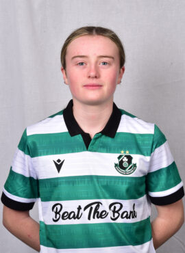 Female Shamrock Rovers player in green and white jersey, standing confidently.