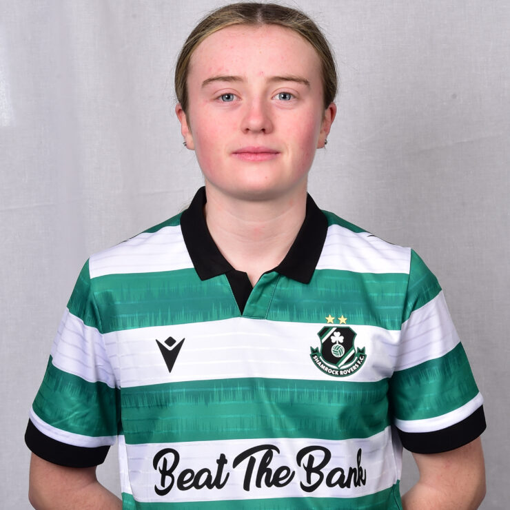 Female Shamrock Rovers player in green and white jersey, standing confidently.