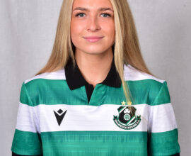 Female footballer in Shamrock Rovers jersey smiling at camera.