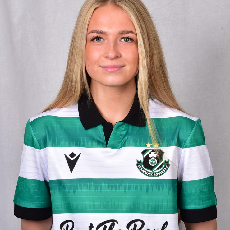 Female footballer in Shamrock Rovers jersey smiling at camera.