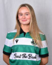 Female football player in Shamrock Rovers jersey smiling.