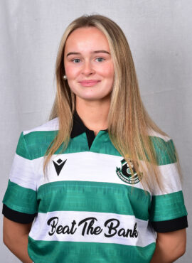 Female football player in Shamrock Rovers jersey smiling.