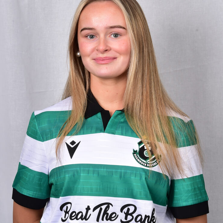 Female football player in Shamrock Rovers jersey smiling.