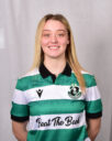 Female Shamrock Rovers player in green and white jersey smiling.