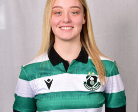 Female Shamrock Rovers player in green and white jersey smiling.