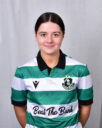 Female Shamrock Rovers player in green and white jersey, smiling.