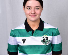 Female Shamrock Rovers player in green and white jersey, smiling.