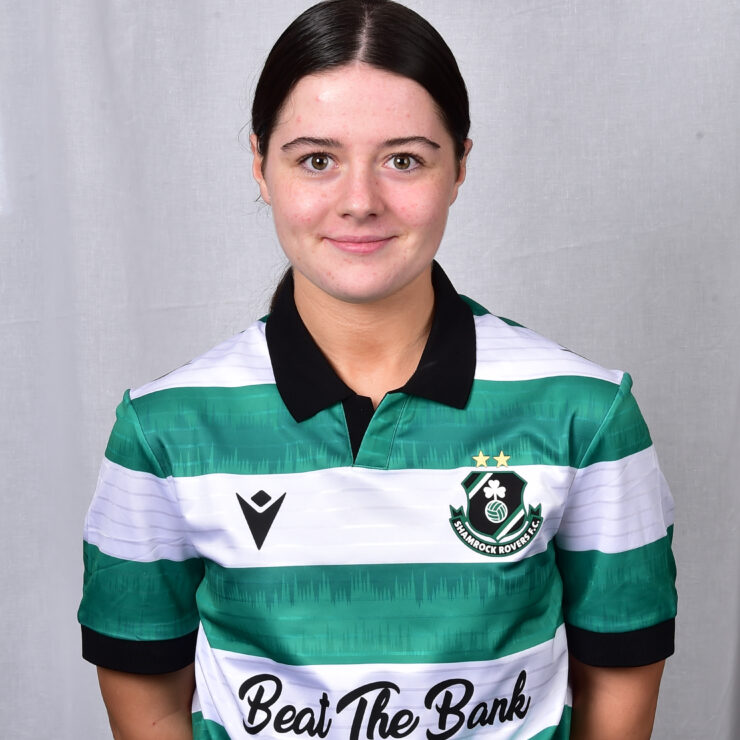 Female Shamrock Rovers player in green and white jersey, smiling.