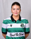 Female Shamrock Rovers player in green and white jersey smiling outdoors.
