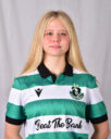 Young female Shamrock Rovers player in team jersey, smiling confidently.