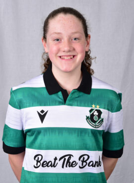 Female Shamrock Rovers player in green and white jersey smiling.