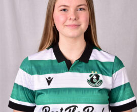 Female Shamrock Rovers player in green and white jersey smiling.