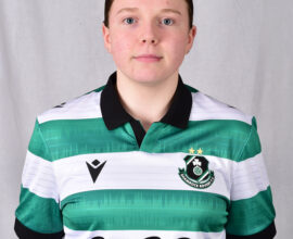 Female Shamrock Rovers football player in team jersey.