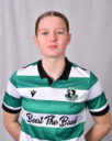 Female Shamrock Rovers player in green and white jersey, standing confidently.