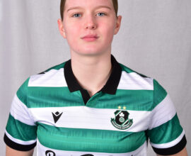 Female Shamrock Rovers player in green and white jersey, standing confidently.