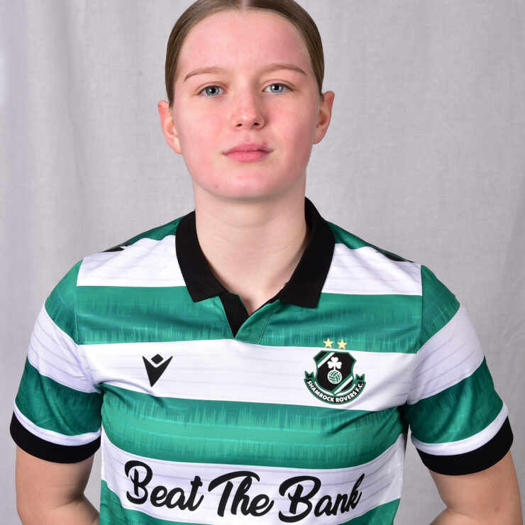 Female Shamrock Rovers player in green and white jersey, standing confidently.