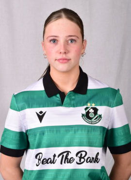 Female Shamrock Rovers player in green and white jersey, close-up portrait.