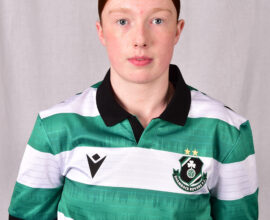 Female footballer in Shamrock Rovers jersey, showcasing team pride and sportsmanship.