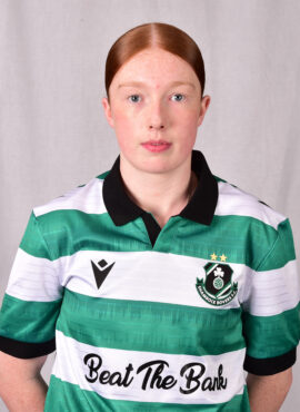 Female footballer in Shamrock Rovers jersey, showcasing team pride and sportsmanship.
