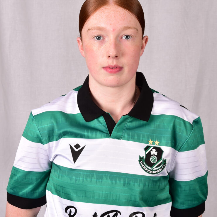 Female footballer in Shamrock Rovers jersey, showcasing team pride and sportsmanship.